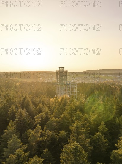 Wooded landscape with a panoramic tower in the distance at sunset, Himmelsglück observation tower with flying fox, Schömberg, Black Forest, Germany