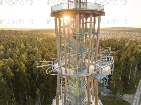 Spire at setting sun surrounded by thick forests, Himmelsglück observation tower with Flying Fox, Schömberg, Black Forest, Germany