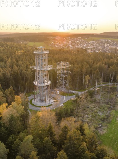 Tower in the forest at sunset, a village visible in the distance, Himmelsglück observation tower with Flying Fox, Schömberg, Black Forest, Germany