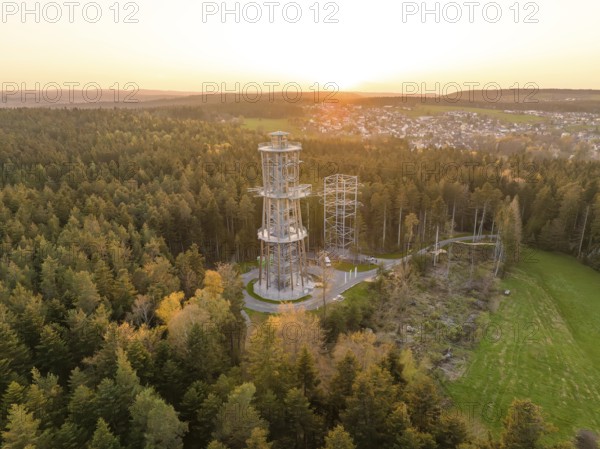 Wide view of the forest with tower and adjacent village in the evening light, Himmelsglück observation tower with Flying Fox, Schömberg, Black Forest, Germany