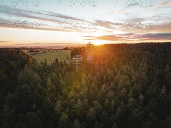 Sunset over a large forest with visible observation tower, Himmelsglück observation tower with Flying Fox, Schömberg, Black Forest, Germany