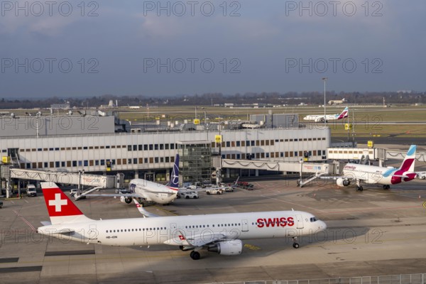 Düsseldorf airport, DUS, terminal A Eurowings aircraft at the gate, Swiss Airbus A321-200 aircraft on their way to takeoff