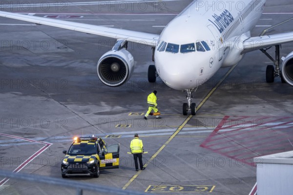 Apron supervision, Lufthansa Airbus is instructed to the parking position at the gate, at Cologne/Bonn Airport, North Rhine-Westphalia, Germany