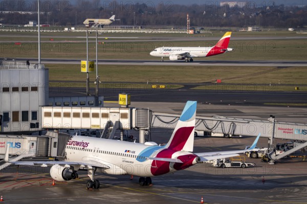 Düsseldorf airport, DUS, terminal A Eurowings plane at the gate, Iberia One World plane after landing