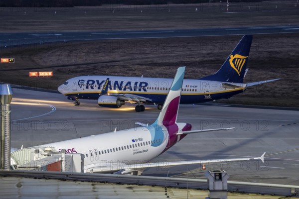 Ryanair Boeing 737-800 after landing at Cologne/Bonn airport, on the taxiway to the terminal, Eurowings plane at the gate, North Rhine-Westphalia, Germany
