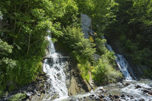 Double waterfall in dense vegetation flows into a river, Borjomi resort, Borjomi, waterfall in Borjomi Park, Samtskhe-Javakheti region, Lesser Caucasus, Georgia