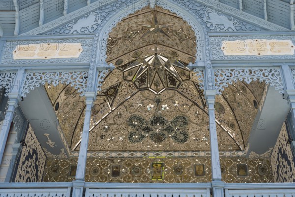 Detail of a richly decorated blue façade with symmetrical patterns, old villa villa of Mirza-Riza-Khan from the 19th century, cultural monument, Golden Tulip Borjomi resort, Borjomi, Kura river, Samtskhe—Javakheti region, Lesser Caucasus, Georgia