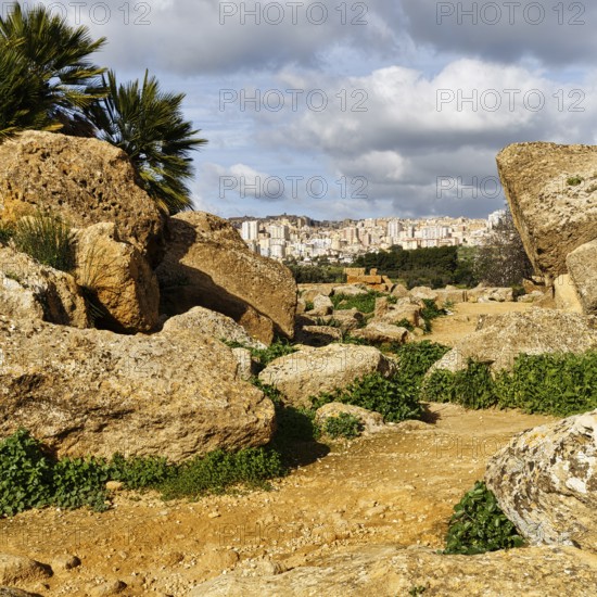 View through boulders of the modern city of Agrigento, Valley of the Temples, Agrigento, Sicily, Italy