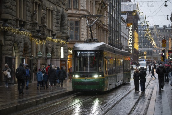 Alexanterinkatu, main shopping street in the city center, designed by Carl Ludwig Engel, with Stockmann department store, Christmas decoration, tram, Helsinki, Finland