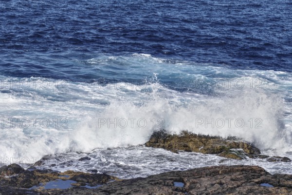 High waves break at full speed on a rocky coast, Yaiza Lanzarote