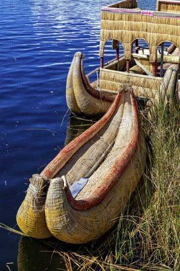Traditional reed boat on the water in a natural setting, The floating reed islands of the Uros in Lake Titicaca in Peru