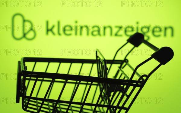 Dhaka, Bangladesh- 03 July 2025: Silhouette of a shopping cart in front of the Kleinanzeigen logo, symbolizing ecommerce and online shopping