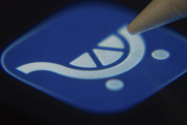 Dhaka, Bangladesh- 06 Dec 2025: Close-up of the Kroger app on a screen with a stylus pointing at it