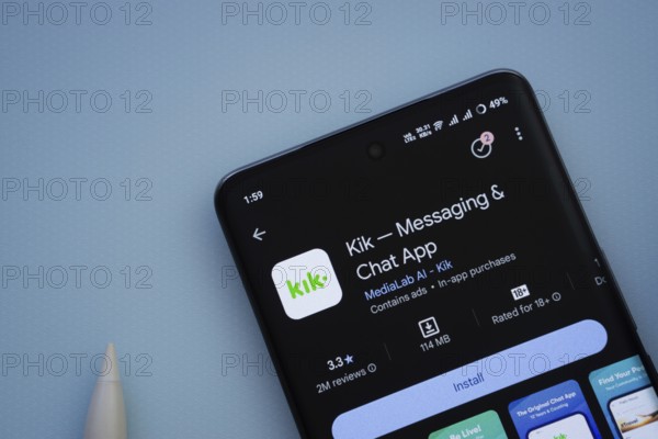 Dhaka, Bangladesh- 29 May 2025: On a blue surface, a smartphone displays the Kik app within the Google Play Store