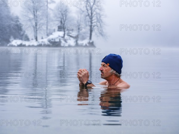 Man with cap, 55, ice bathing, including winter bathing in Königssee, Schönau am Königssee, Berchtesgadener Land, Upper Bavaria, Bavaria, Germany