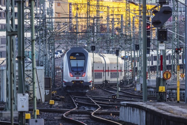 InterCity IC to Zurich leaving Stuttgart Central Station in the morning. Rail signals and overhead lines in early morning light. Stuttgart, Baden-Württemberg, Germany