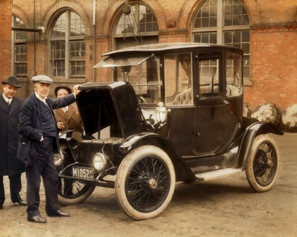 Thomas Alva Edison displaying storage batteries of the power Detroit Electric automobile, 1913, digitally edited