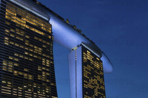 Marina Bay Sands, MBS, luxury 5-star hotel and integrated resort illuminated at dusk in Downtown Core of the city Singapore, Southeast Asia
