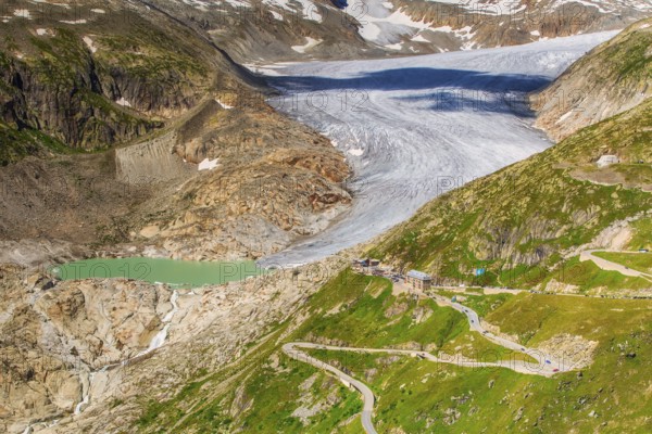 View of the Rhone Glacier, Belvédère Hotel, and Furka Pass on a summer day, highlighting climate change and global warming, Oberwald, Goms, Valais Canton, Switzerland