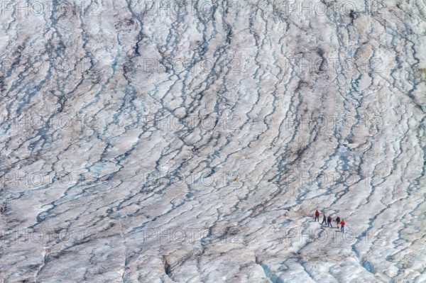 Mountaineers walk on the Rhone Glacier, highlighting climate change and global warming, Oberwald, Goms, Valais Canton, Switzerland