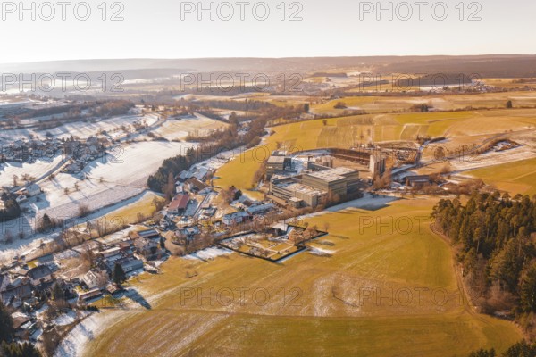 Wide winter field landscape with buildings and horizon at sunrise, Hallwangen, Freudenstadt district, Germany