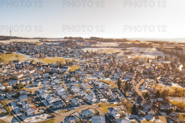 Bird's-eye view of rural winter landscape with snow-covered houses and fields, Hallwangen, Freudenstadt district, Germany