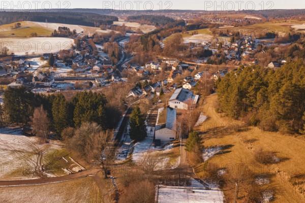 Snowy village nestled in a hilly landscape with forest and fields, Aach, Dornstetten, Freudenstadt district, Germany