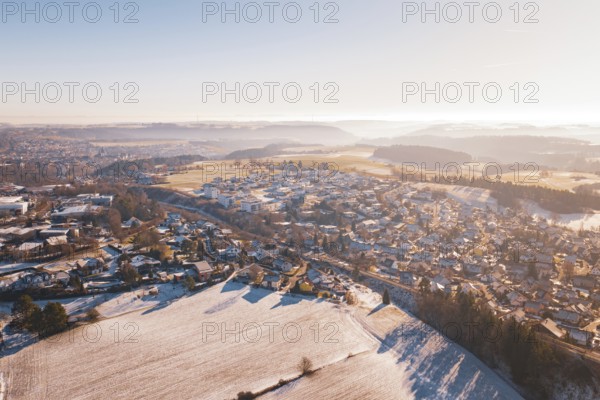 Aerial view of a snowy village in hilly landscape under bright sky, Aach, Dornstetten, Freudenstadt district, Germany