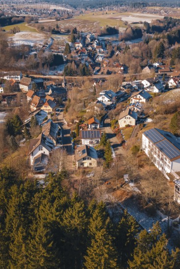 Aerial view of a snowy village surrounded by thick forests and hills, Aach, Dornstetten, Freudenstadt district, Germany