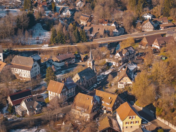 Village in winter with a distinctive church and surrounding snow-covered houses, Aach, Dornstetten, Freudenstadt district, Germany