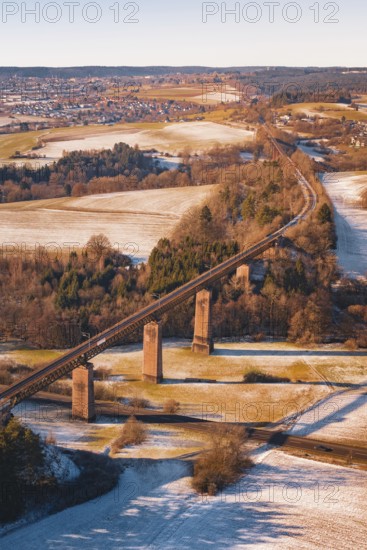 Railway bridge in winter surrounded by snow-covered fields and roads, Dornstetten, Freudenstadt district, Germany