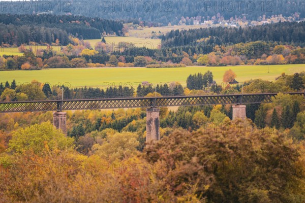Bridge over an autumn landscape with colorful trees and meadows, Dornstetten, Freudenstadt district, Germany