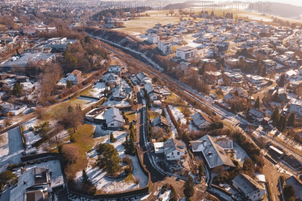 Village area with residential buildings under a light layer of snow in the morning sun, Dornstetten, Freudenstadt district, Germany