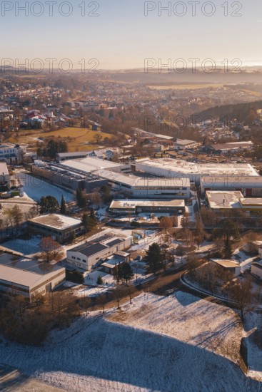 Industrial landscape in winter with buildings under clear sky in soft sunlight, Dornstetten, Freudenstadt district, Germany