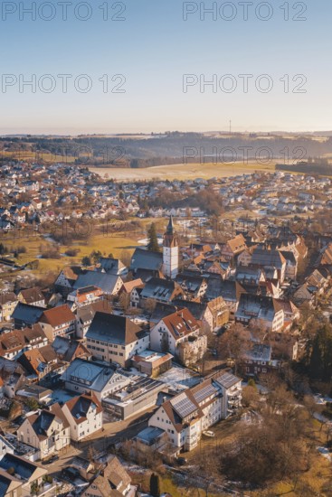City view from the air with church architecture, surrounded by red roofs, in a winter landscape, Dornstetten, Freudenstadt district, Germany