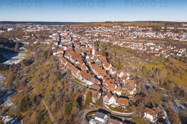 Aerial view of city in winter surroundings with characteristic red roofs, Dornstetten, Freudenstadt district, Germany