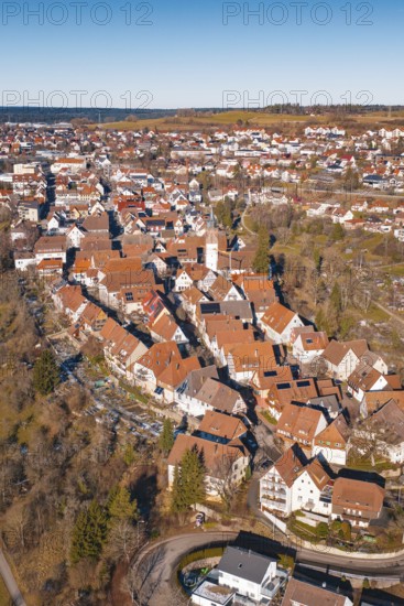 Aerial view of dense buildings with red roof tiles in a wintry environment, Dornstetten, Freudenstadt district, Germany
