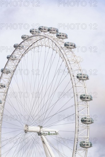 A majestic Ferris wheel dominates the cloudy sky with its capsules, London Eye, London, United Kingdom