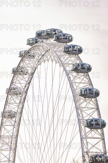 Close-up of a Ferris wheel with glass and metal cabins, London Eye, London, United Kingdom