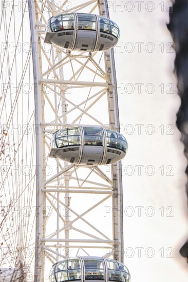 Close-up of a Ferris wheel with futuristic cabins against a bright sky, London Eye, London, United Kingdom