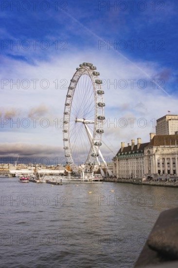 Cityscape with Ferris wheel on riverbank in good weather, London Eye, London, United Kingdom