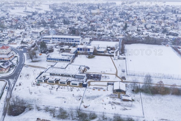 Modern and traditional buildings in a snowy village with streets and squares, Empfingen, Freudenstadt district, Germany