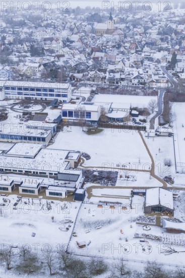 Aerial view of a sprawling village with snowy roofs and roads, Empfingen, Freudenstadt district, Germany
