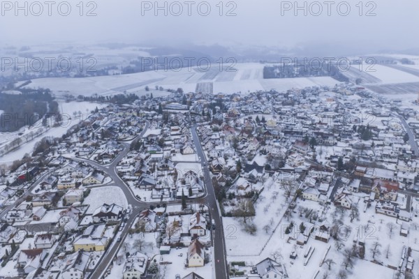 View of a snowy town and surrounding fields surrounded by grey sky, Empfingen, Freudenstadt district, Germany