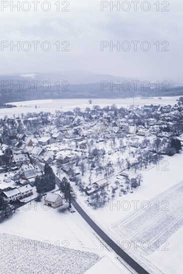 Snowy village surrounded by fields and trees in a wintry landscape, Wiesenstetten, Freudenstadt district, Germany