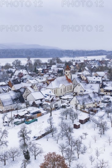 Village in winter with snow-covered houses and a church, cold atmosphere, Wiesenstetten, Freudenstadt district, Germany