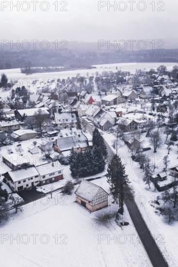 Wintery village with snow-covered houses and trees, cold landscape atmosphere, Wiesenstetten, Freudenstadt district, Germany
