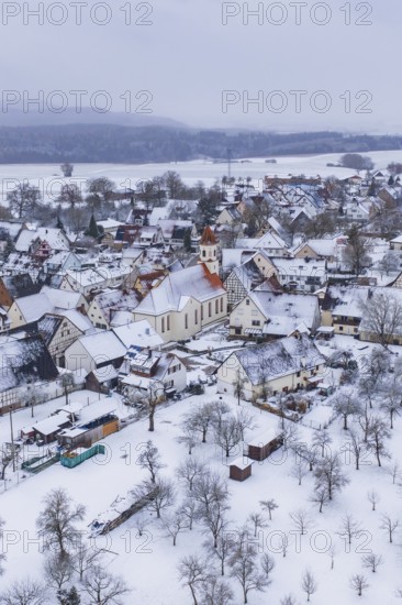 Snowy village with church in the center, surrounded by trees, winter landscape, Wiesenstetten, Freudenstadt district, Germany