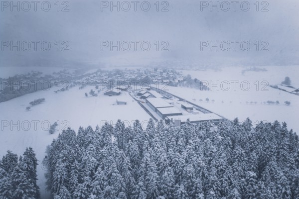 Aerial view of a snowy village surrounded by forests, Hörschweiler, Freudenstadt district, Germany