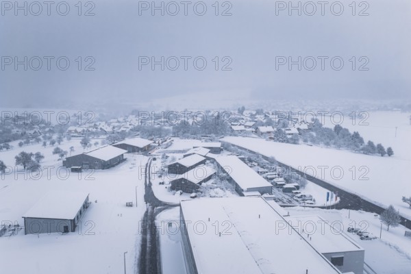 Snow-covered buildings and roads in a quiet village, Hörschweiler, Freudenstadt district, Germany